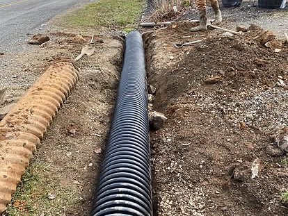 A new culvert and drain pipe being installed along a driveway by Cavalier Cleanup